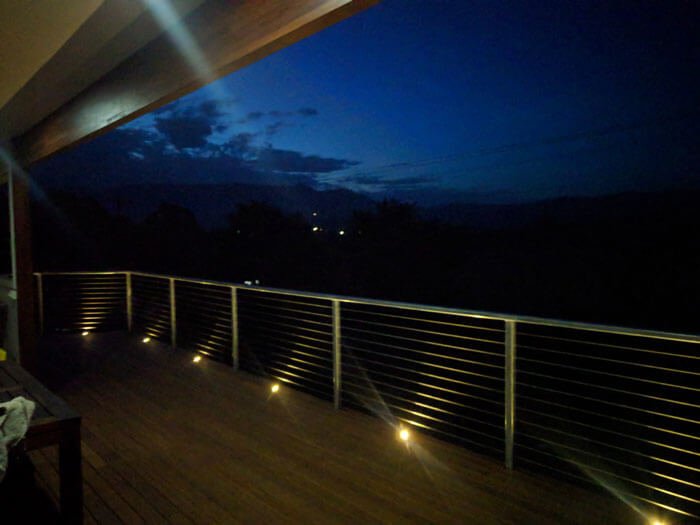 Deck lights installed into wood next o balcony
