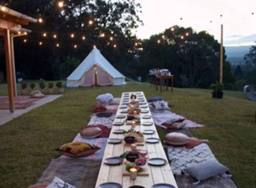 Festoon lights over an outdoor dining table