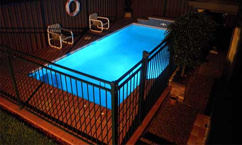 Outdoor gated pool with LED lights installed