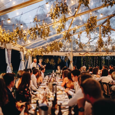 wedding dinner site with decorated festoon lights