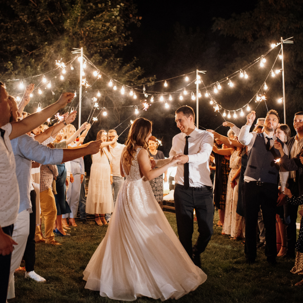 bride and groom dancing under festoon lights setup
