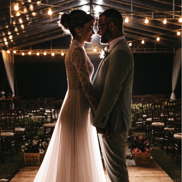 bride and groom under festoon lights